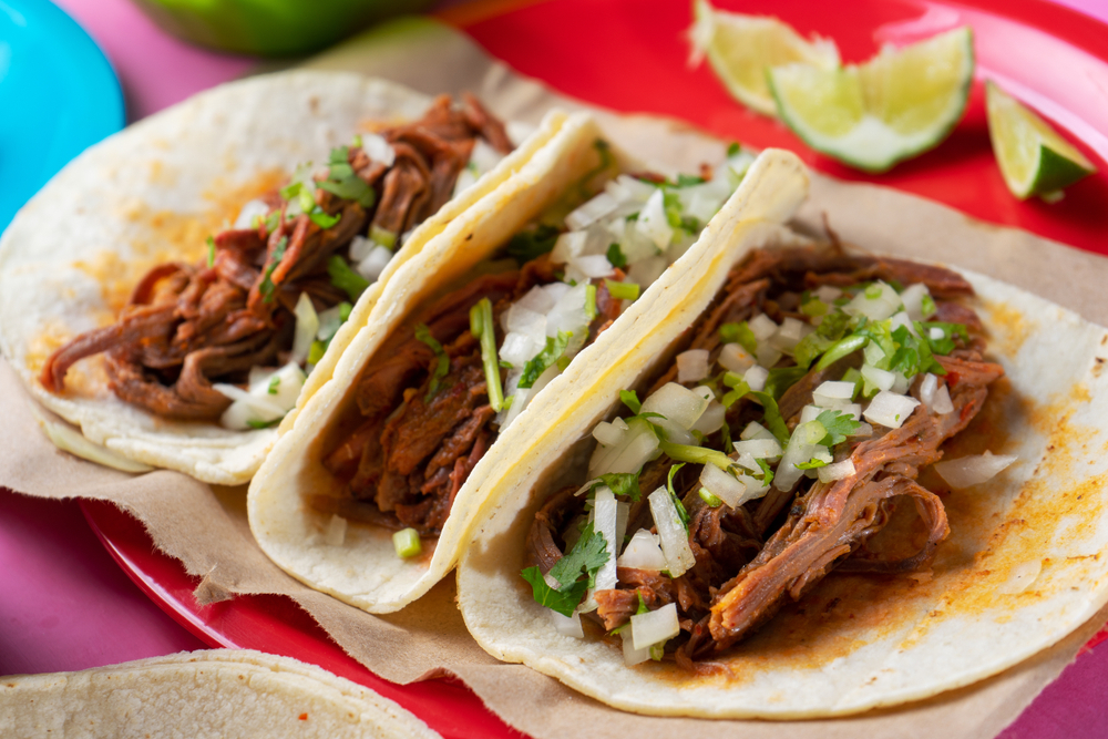 traditional tacos on a colorful background