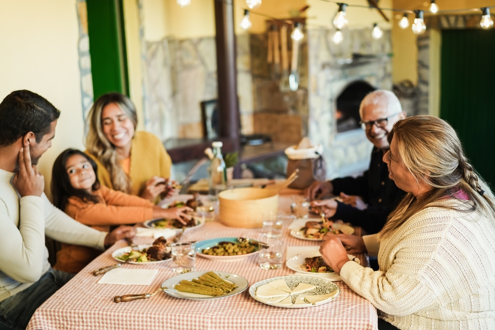 happy latin family eating around table