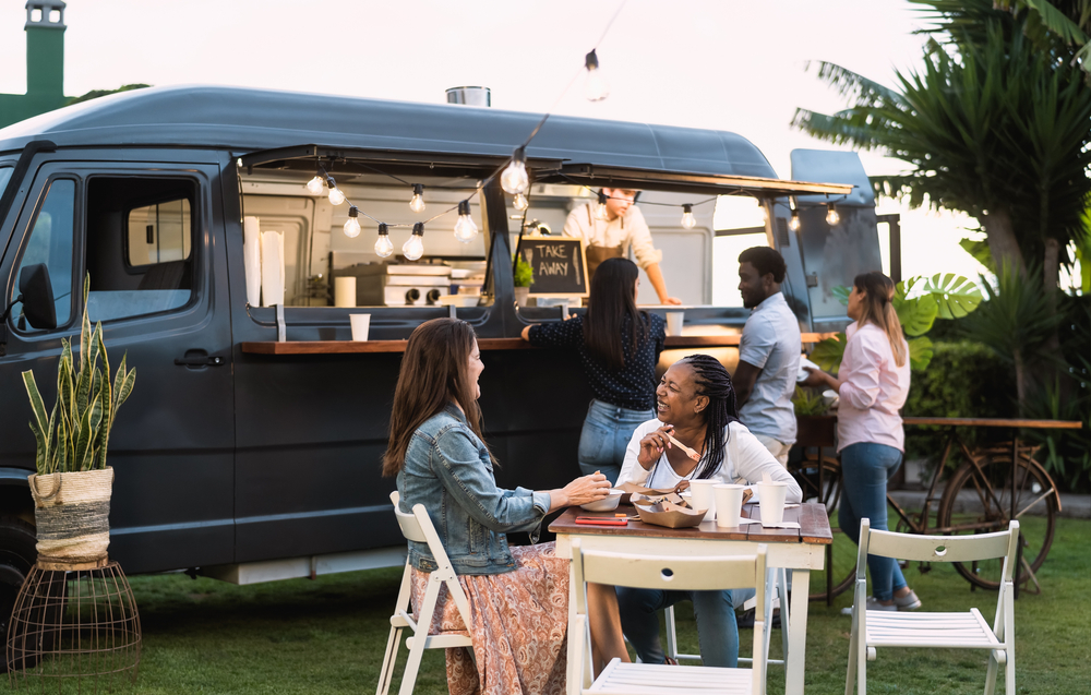 People eating at a food truck