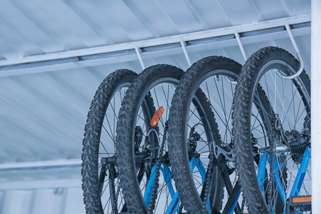 Bikes hanging on ceiling hooks.