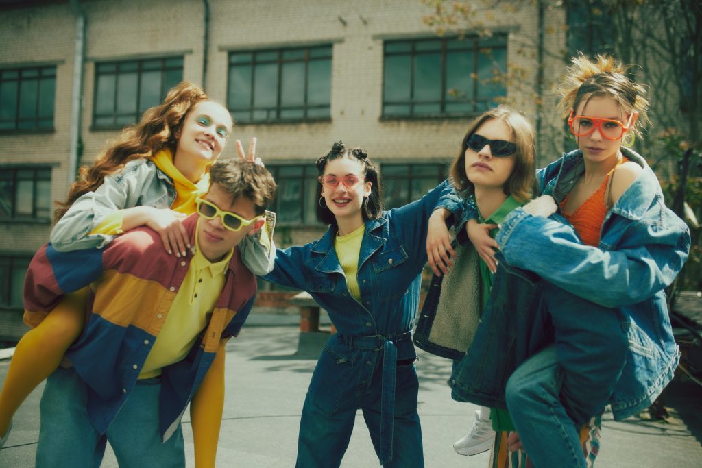 A group of young adults wearing vintage clothes, likely from the  early 1990s.