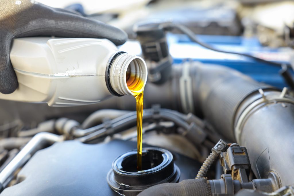 Pouring new oil into an RV motor.