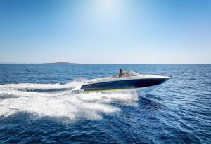 A speed boat skimming across the open ocean.