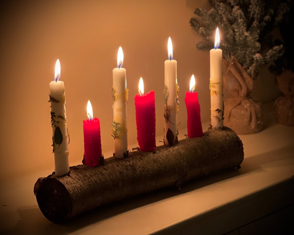 A festive candle holder made from a log.