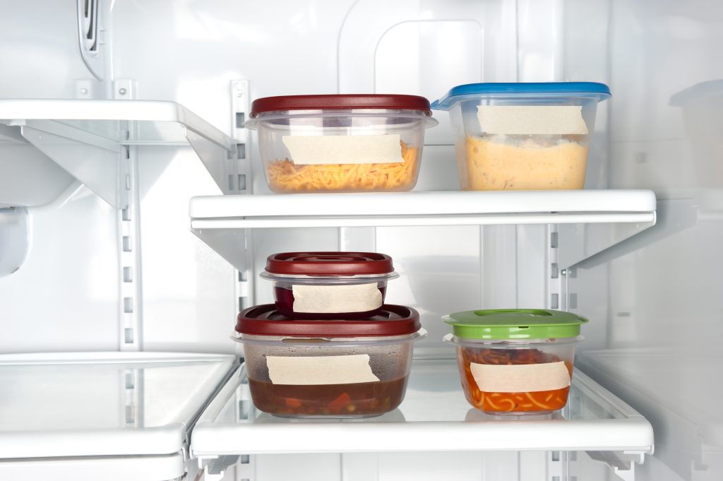 Leftovers in containers in a fridge.