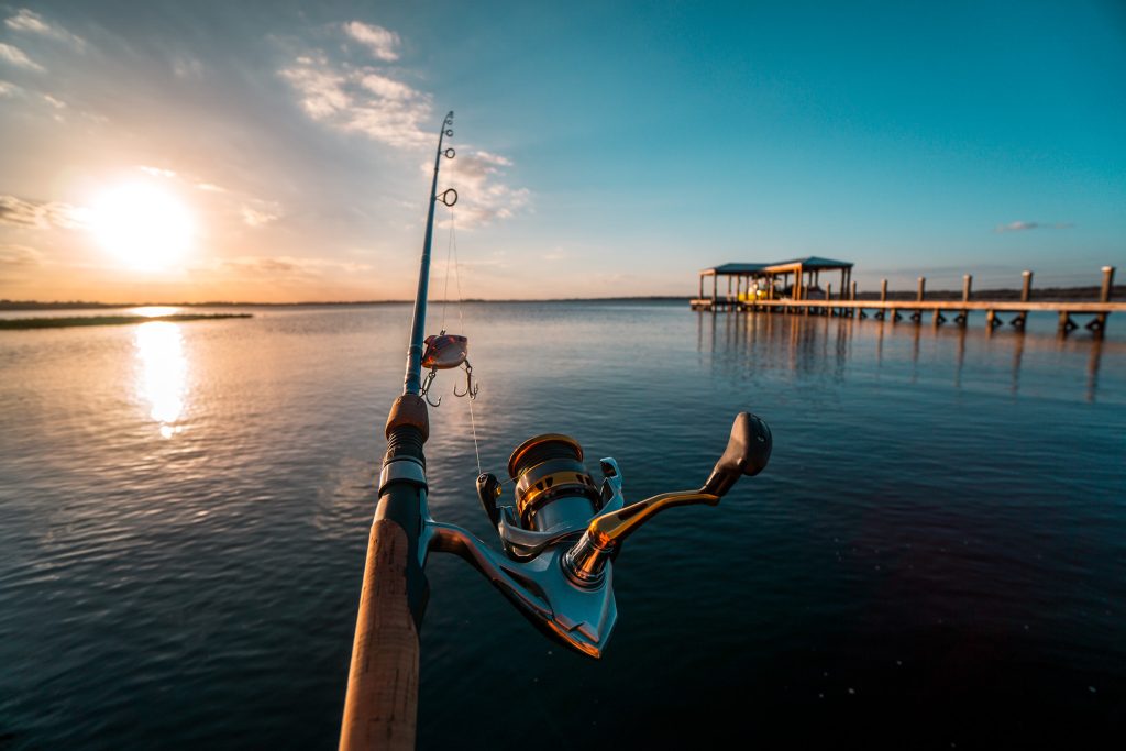 A POV shot from behind a fishing pole cast out over Lake Minneola.