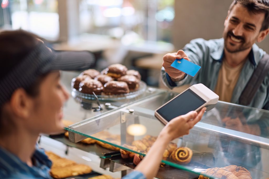 A man buying pastries at a pastry shop.