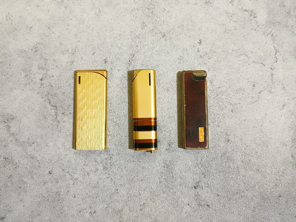 Three vintage lighters.